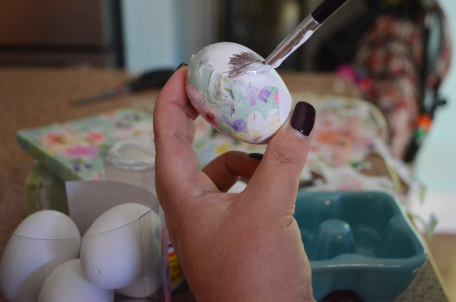 Applying Mod Podge to paper decoupage Easter eggs