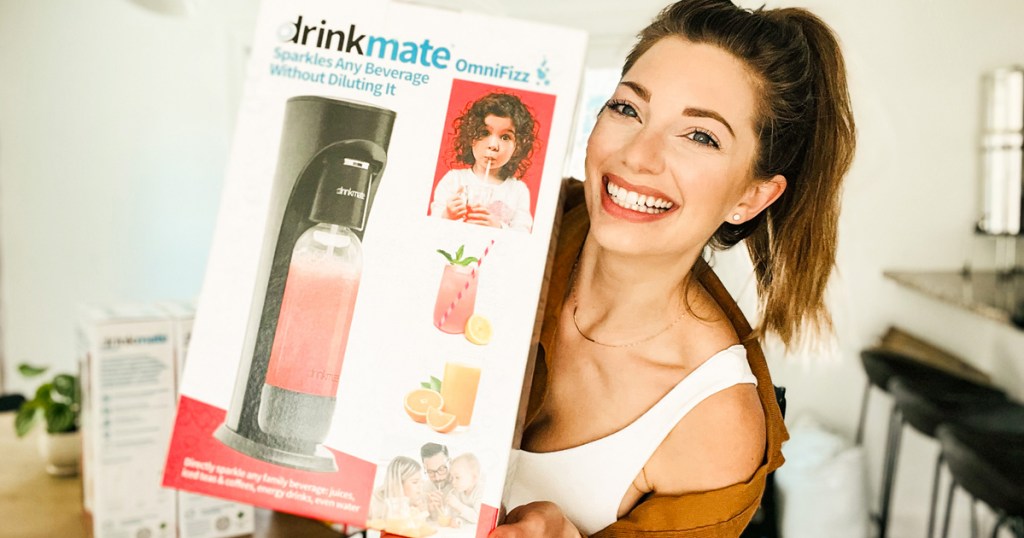 woman holding up box for Drinkmate Carbonated Beverage Maker