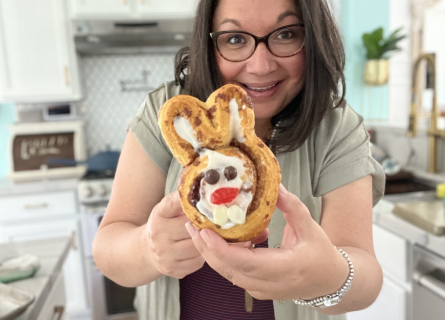 Woman holding up Easter Bunny Cinnamon Rolls