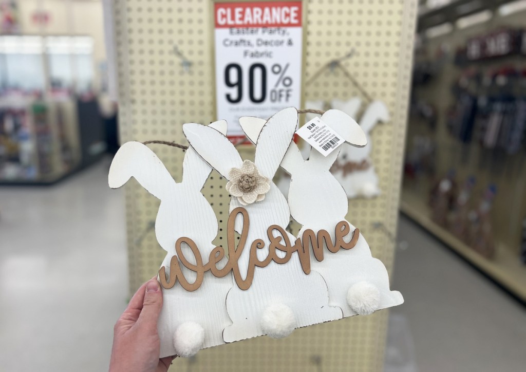 hand holding bunny sign that says welcome