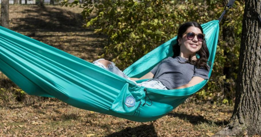 A woman in a green tree hammock