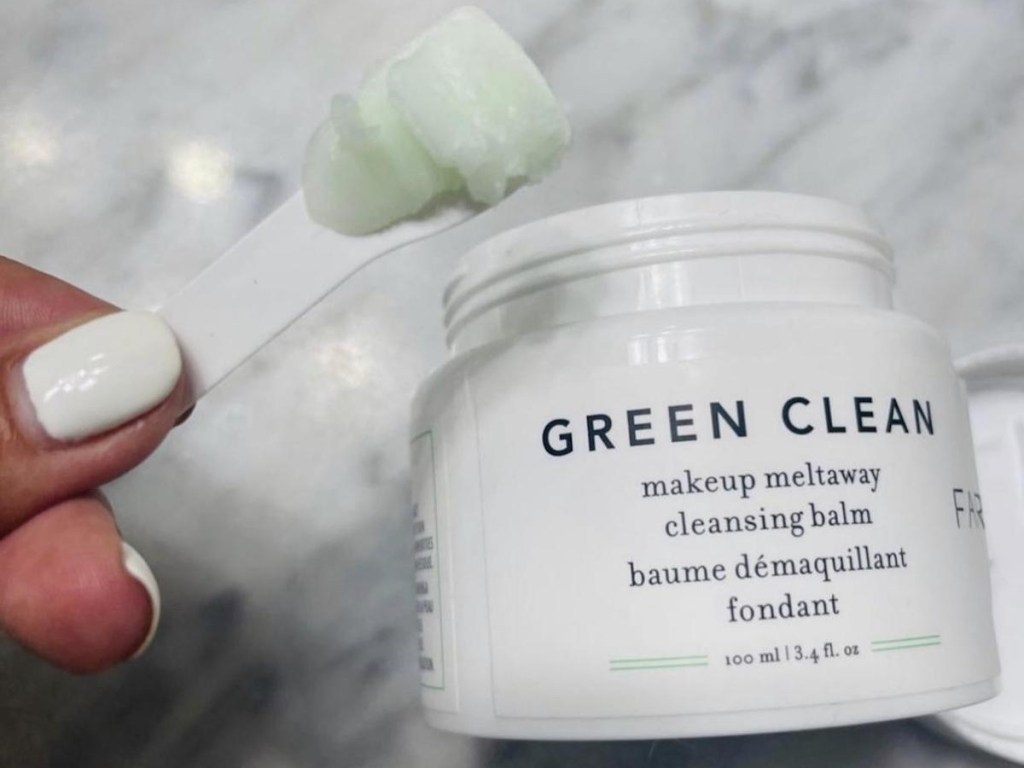 woman scooping Farmacy Mini Green Clean Makeup Meltaway Cleansing Balm