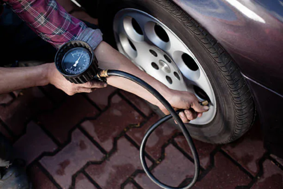 woman checking her tire pressure for free