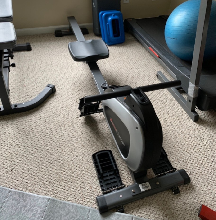 rowing machine on carpet in home gym