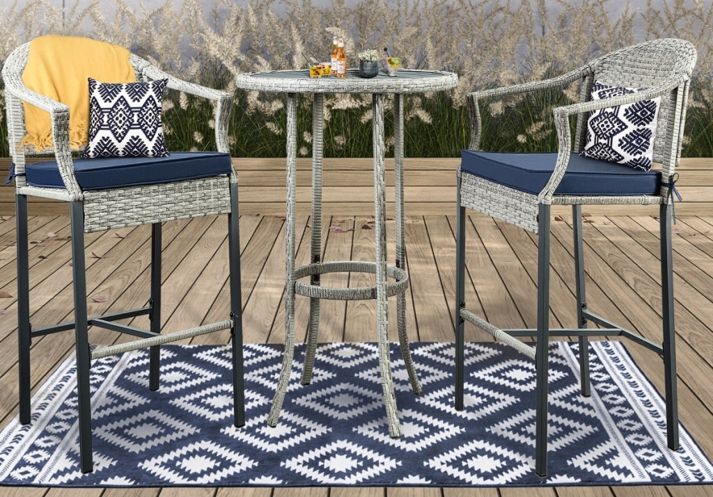 Two patio chairs and a table on a rug
