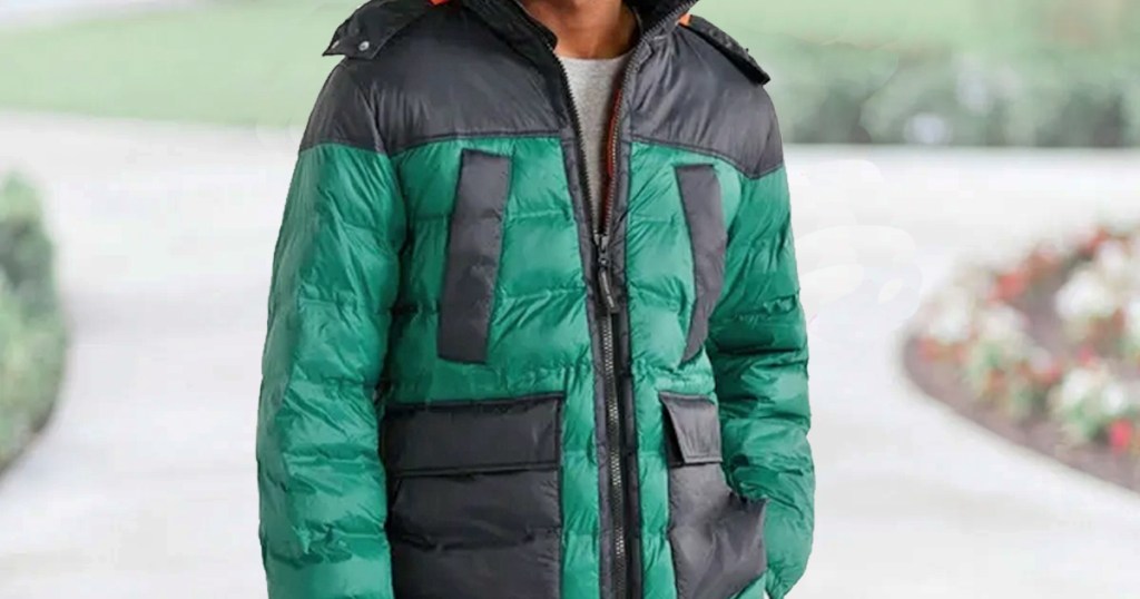 man wearing a green and black color block puffer jacket