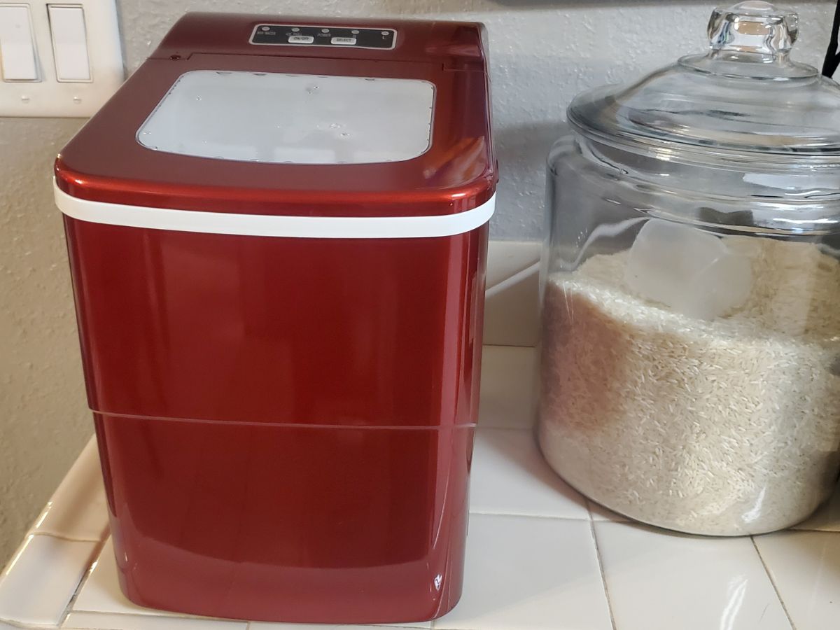 Free Village Ice Maker in Red on a counter next to a canister full of rice