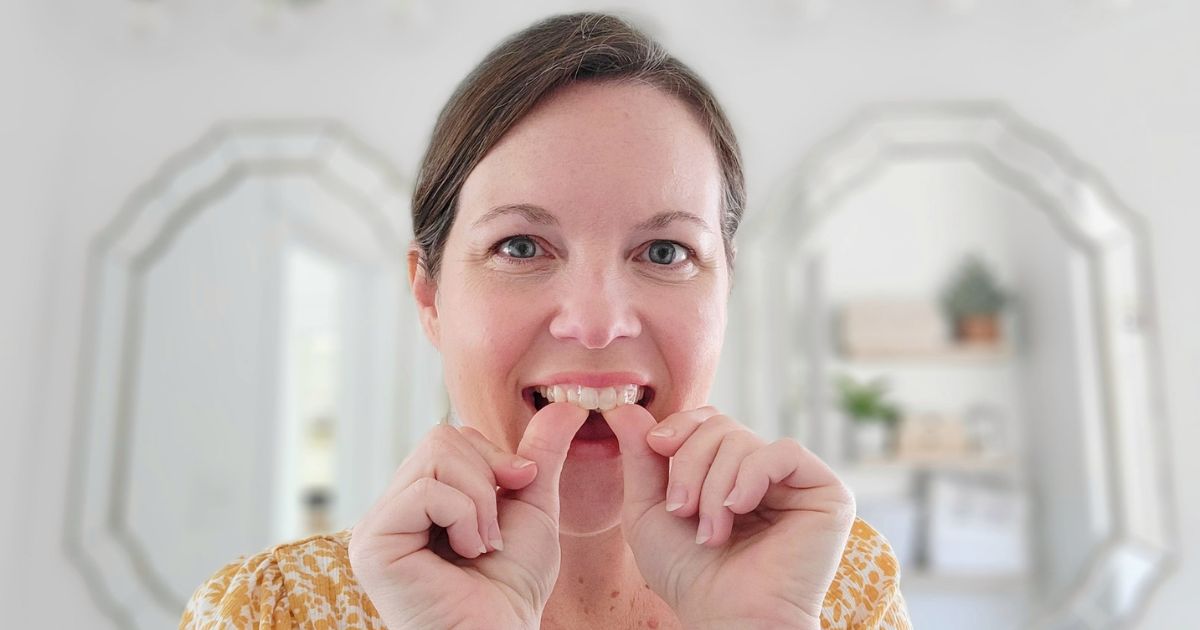 woman showing off whitening strips