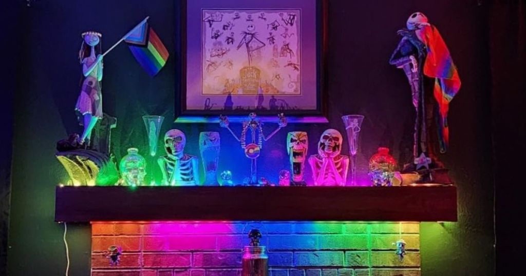 A mantel with The Nightmare Before Christmas halloween decorations with rainbow lighting effect