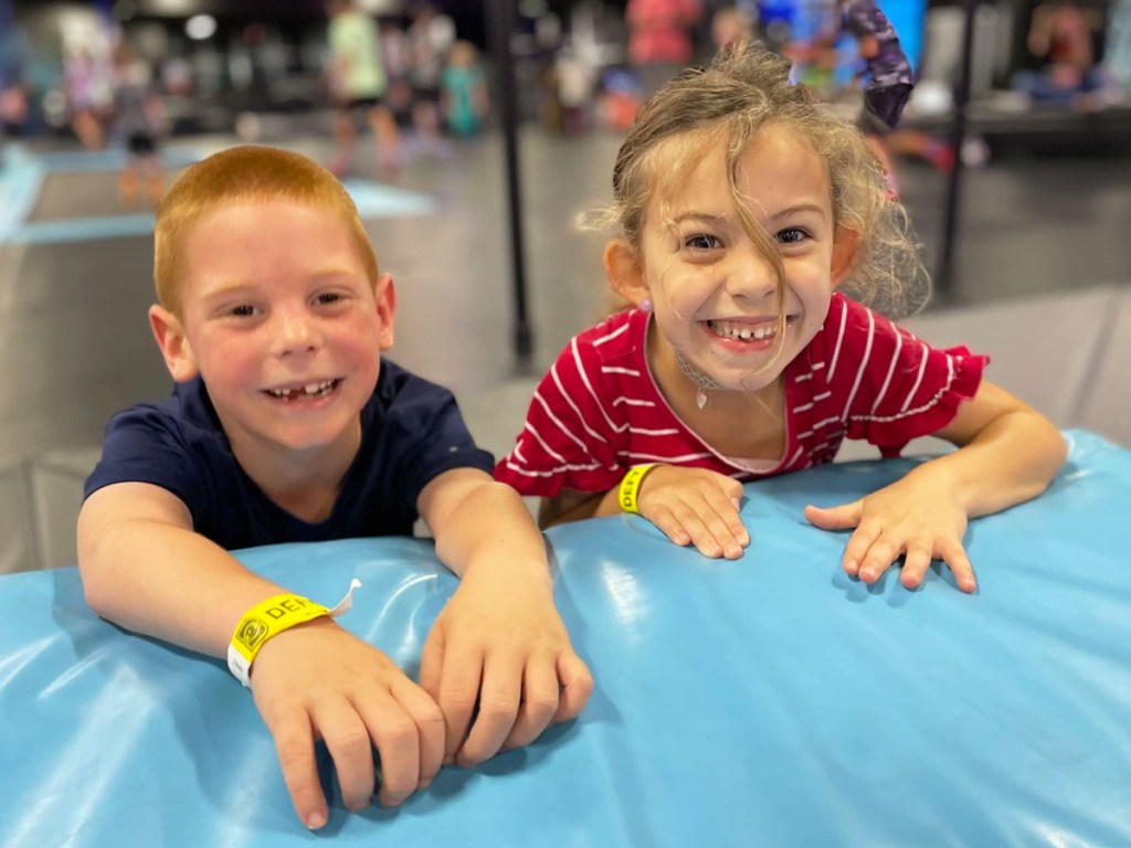 two kids playing at trampoline park