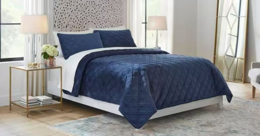 blue velvet comforter and sham set on a bed in a bedroom