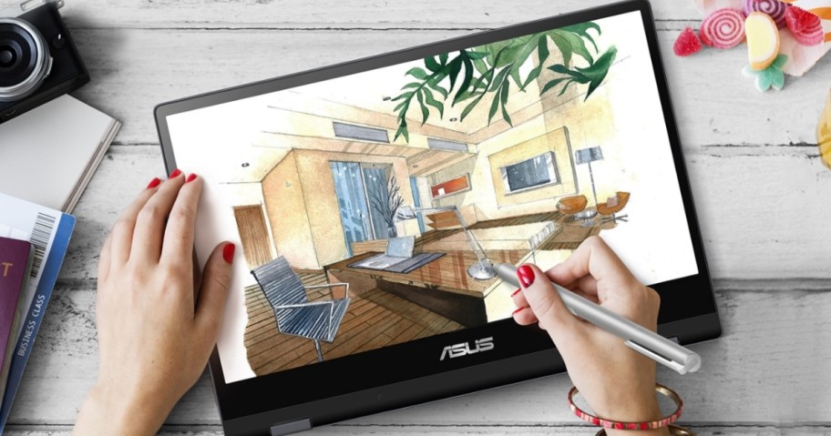 person's hand using a stylus to draw on a touchscreen 2-in-1 Asus laptop that's flipped to work as a tablet