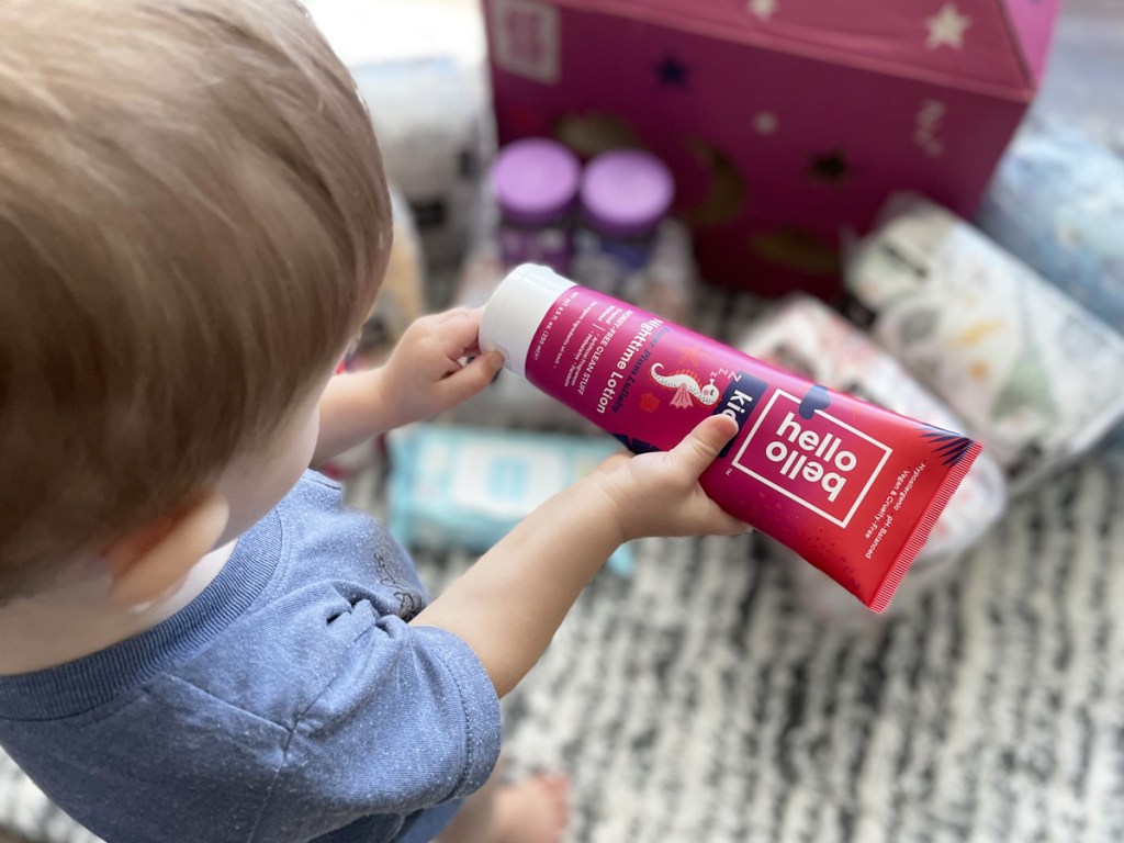 boy holding tube of hello bello lotion