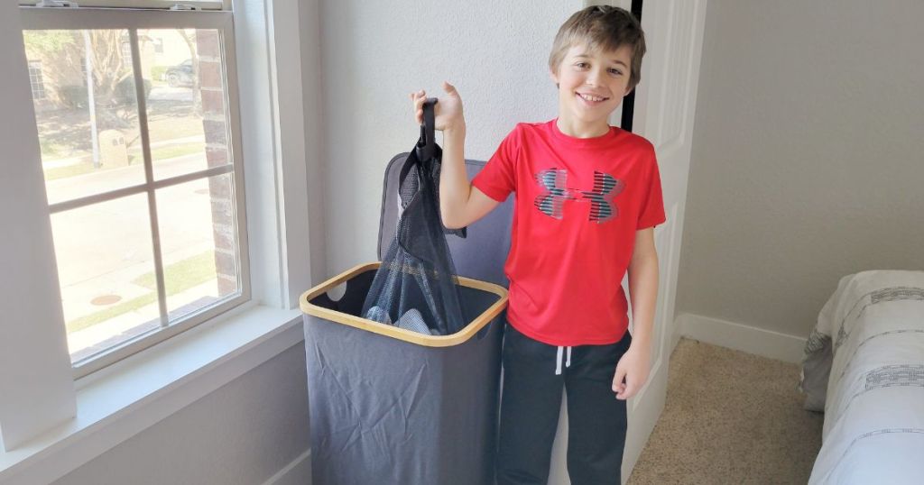 boy taking removable laundry bag from dark gray laundry hamper with bamboo lid base 