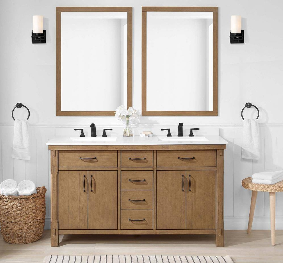 Bathroom with brown vanity and double mirrors above it
