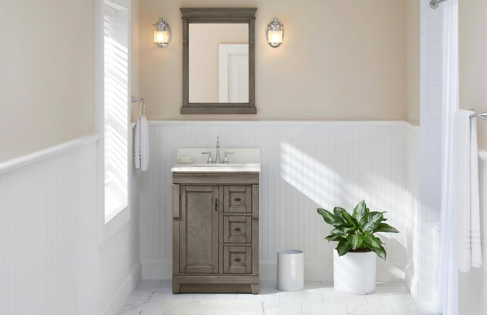 Bathroom with grey vanity and a plant next to it