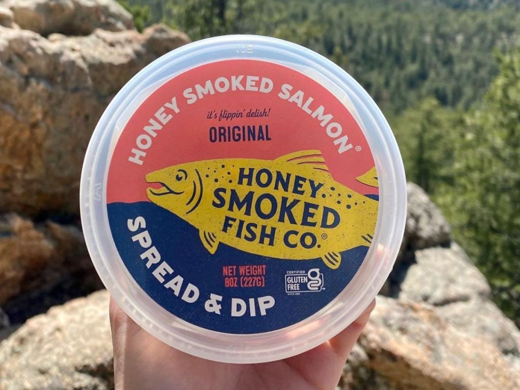 Hand holding a Honey Smoked Fish Co Dip