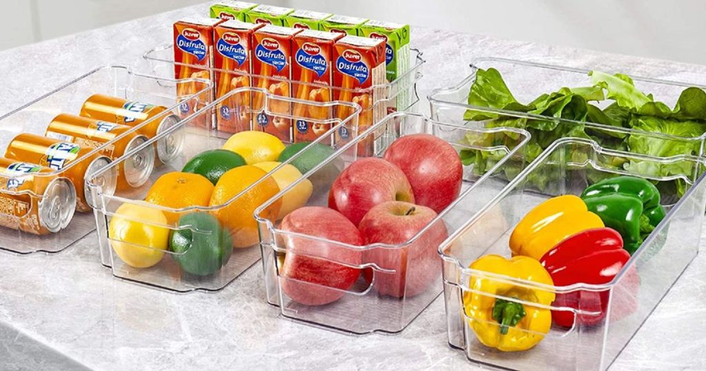 clear bins on counter filled with fruit and veggies and drinks