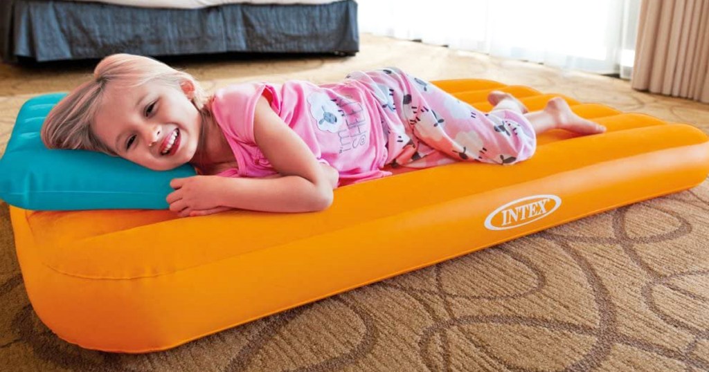 girl laying on an orange air bed
