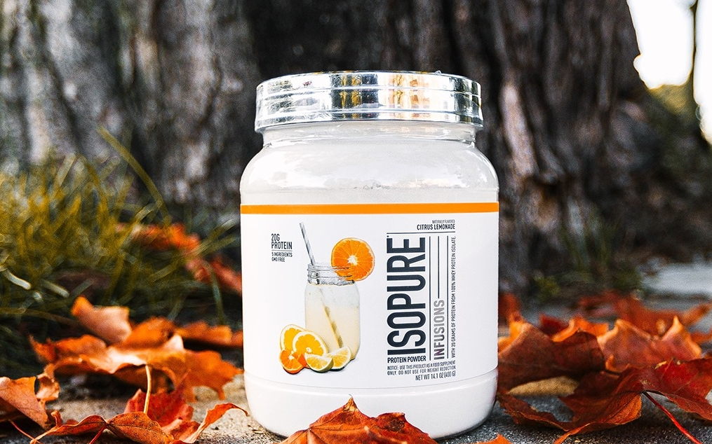 Container of Isopure Citrus Lemonade surrounded by leaves