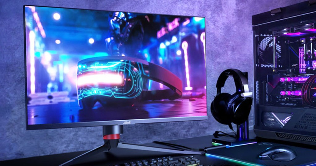 computer monitor next to headphones and rgb computer