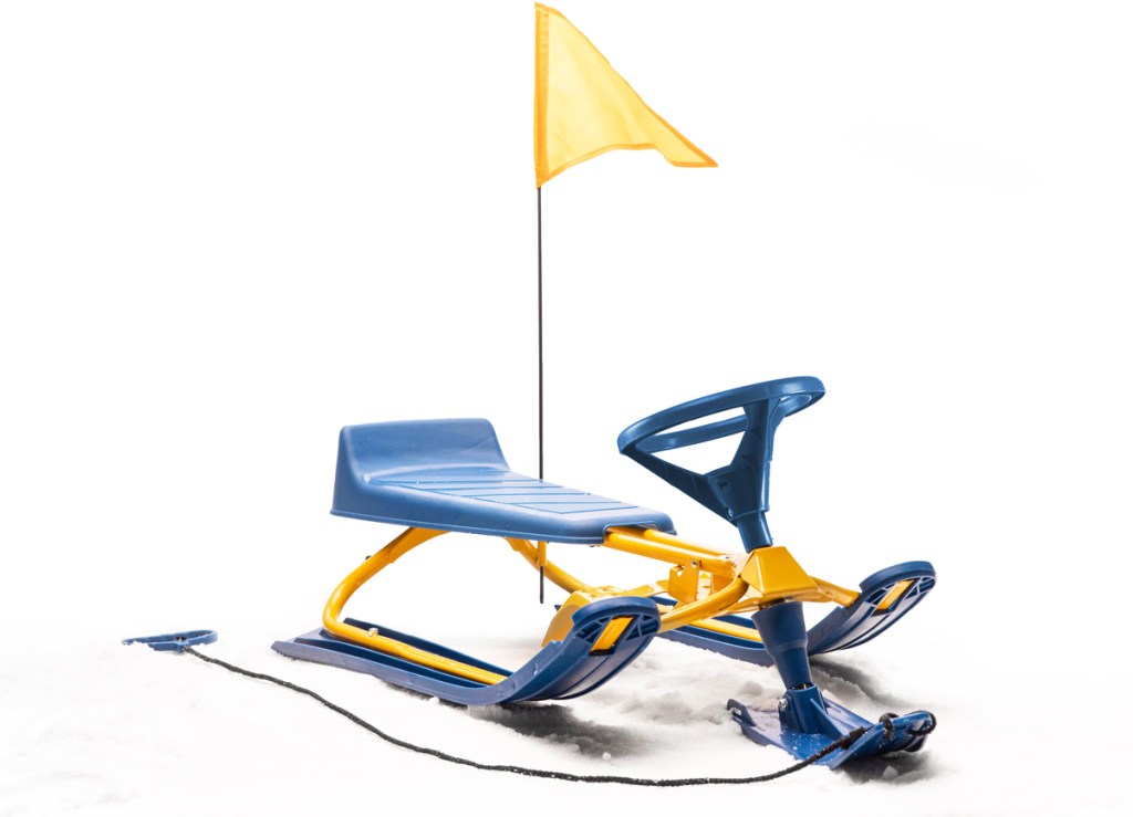 yellow and blue sled in snow with yellow safety flag