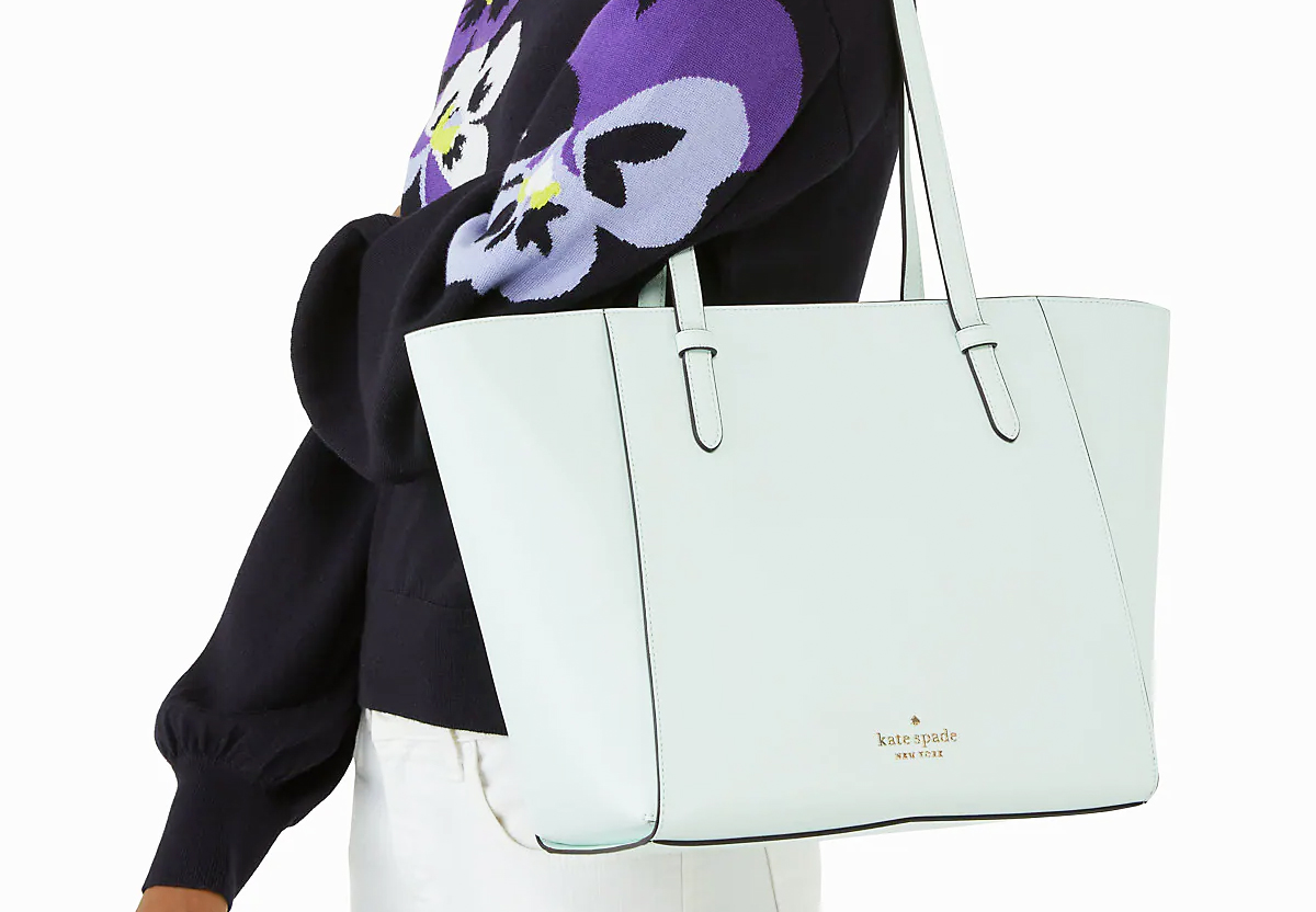 woman with mint green tote bag