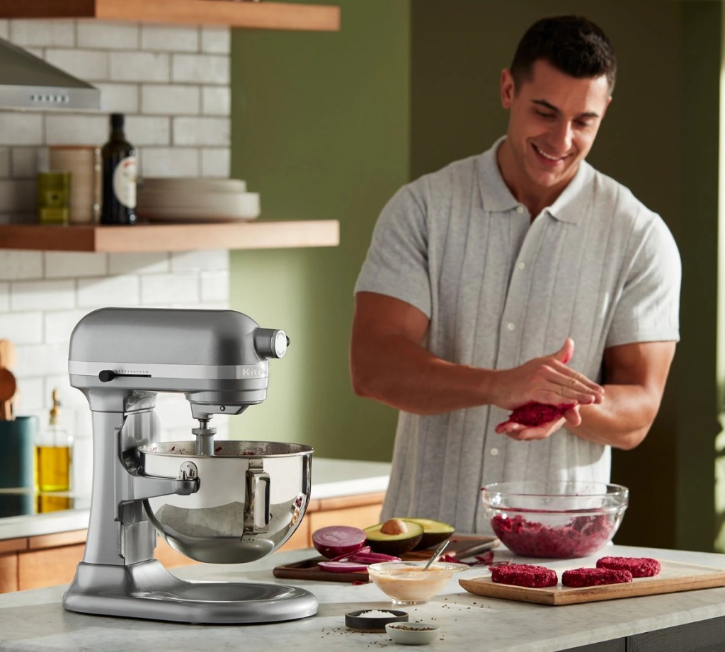 Man making hamburger patties and a KitchenAid mixer on the counter next to him