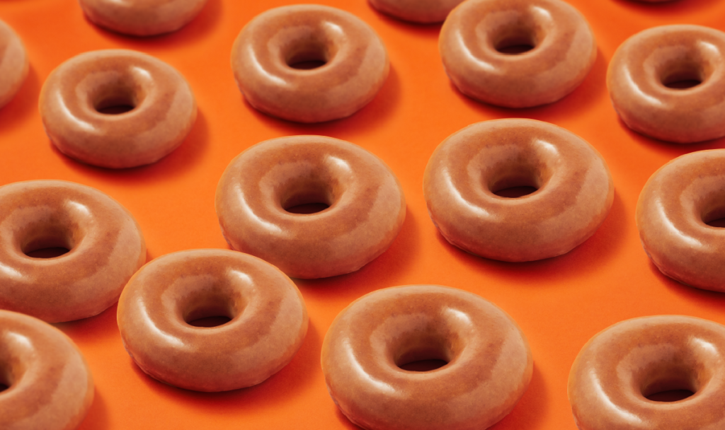 Several Krispy Kreme Pumpkin Spice Original Glazed Doughnuts