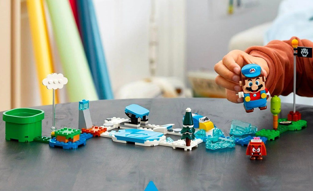 child playing with super mario lego set