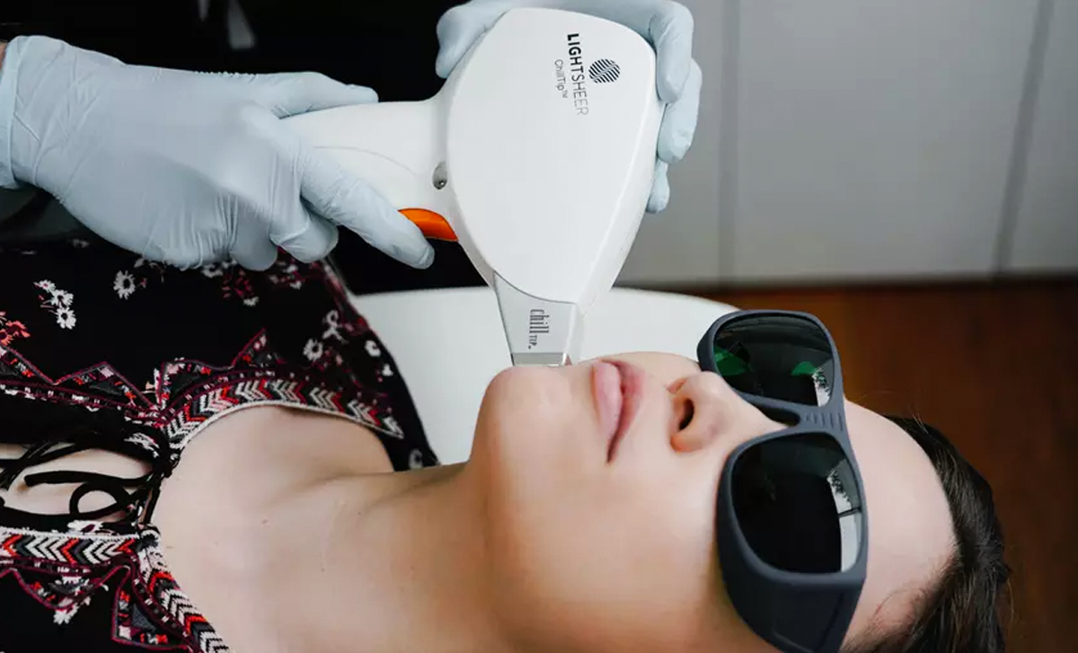 woman getting laser hair removal done on her chin