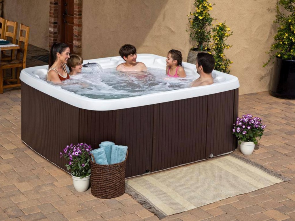 woman and kids sitting in hot tub with jets on