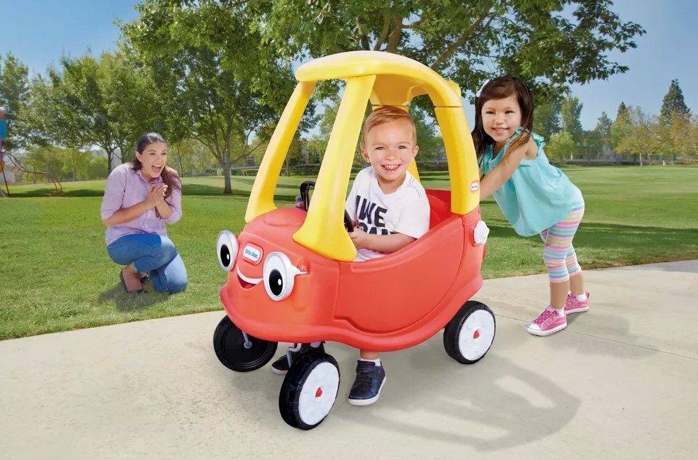 Kids playing in a Little Tikes cozy coupe car