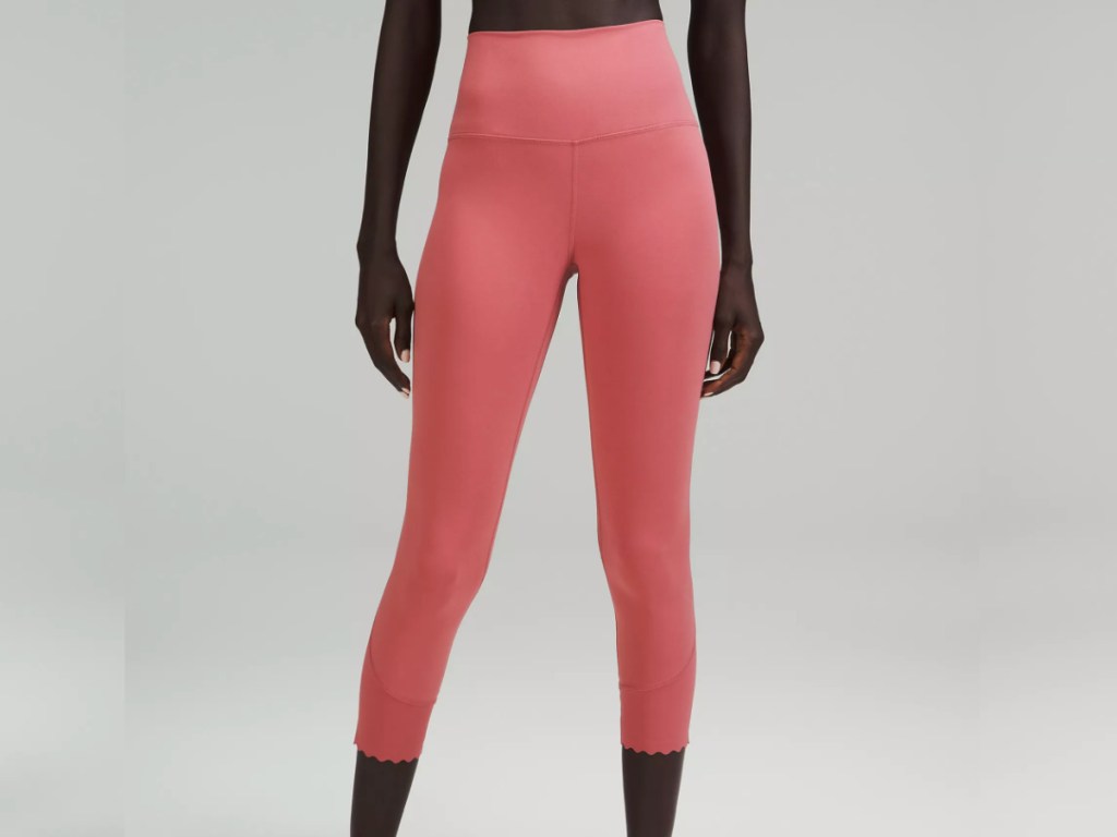 woman wearing pink colored Lulu Scalloped leggings