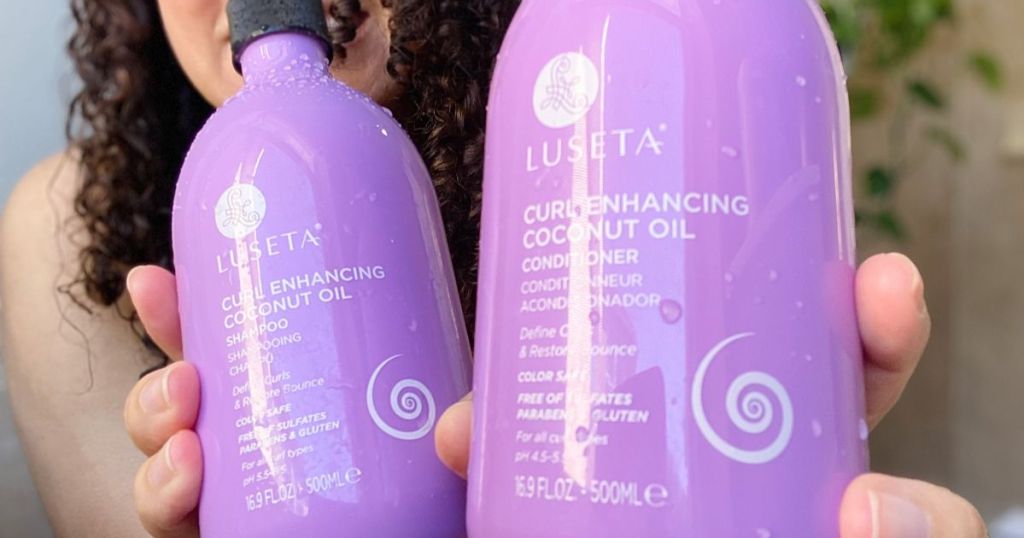 a womans hands golding up bottles of Luseta curl enhancing shampoo & conditioner