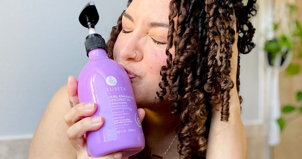a woman kissing a bottle Luseta shampoo