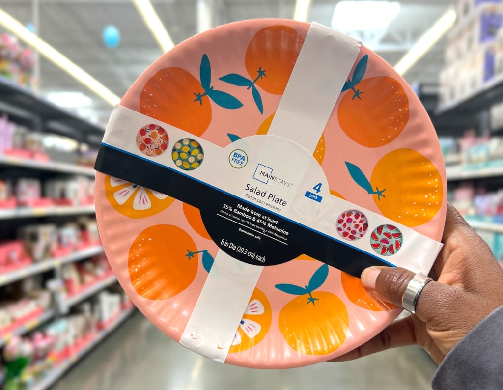 Mainstays Eco-Friendly Bamboo Melamine Salad Plate 4-Pack being held in the aisle at Walmart