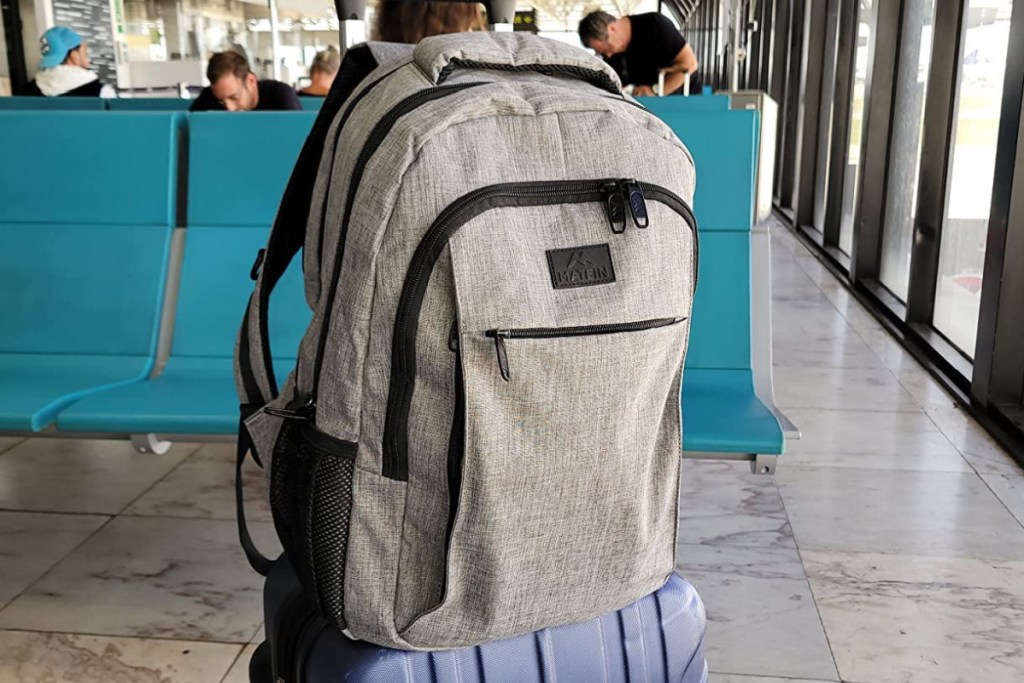 Matein Travel Laptop Backpack on carryon suitcase at the airport