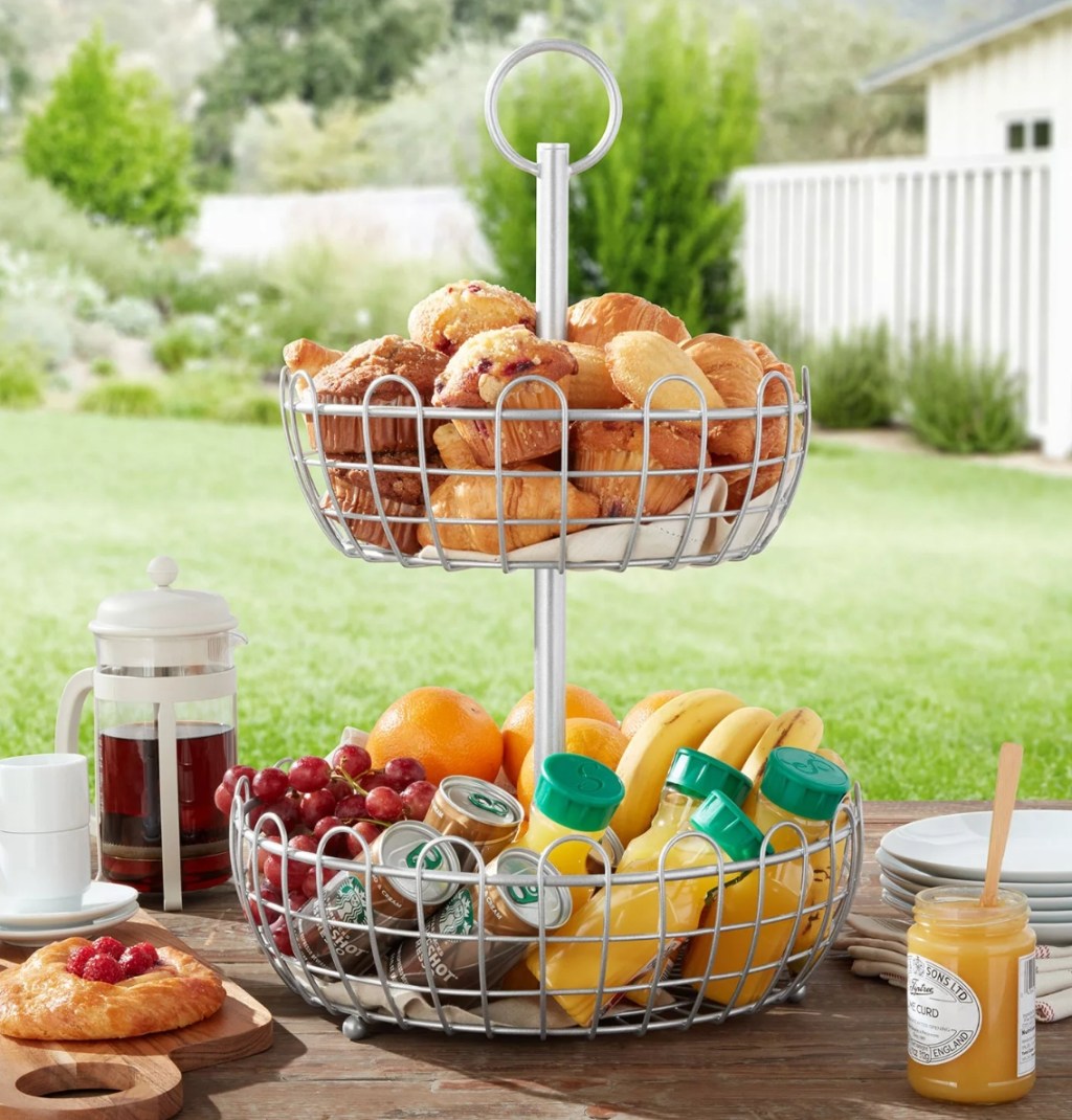 Tiered basket with food and drinks in it