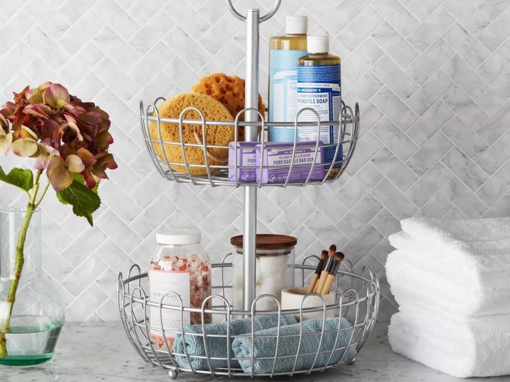 Two tier basket with bathroom supplies in it