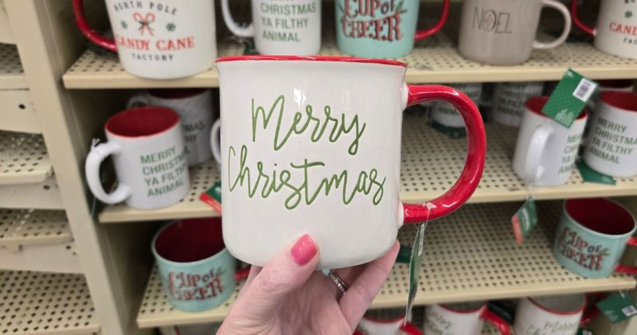 hand holding Merry Christmas Mug in store