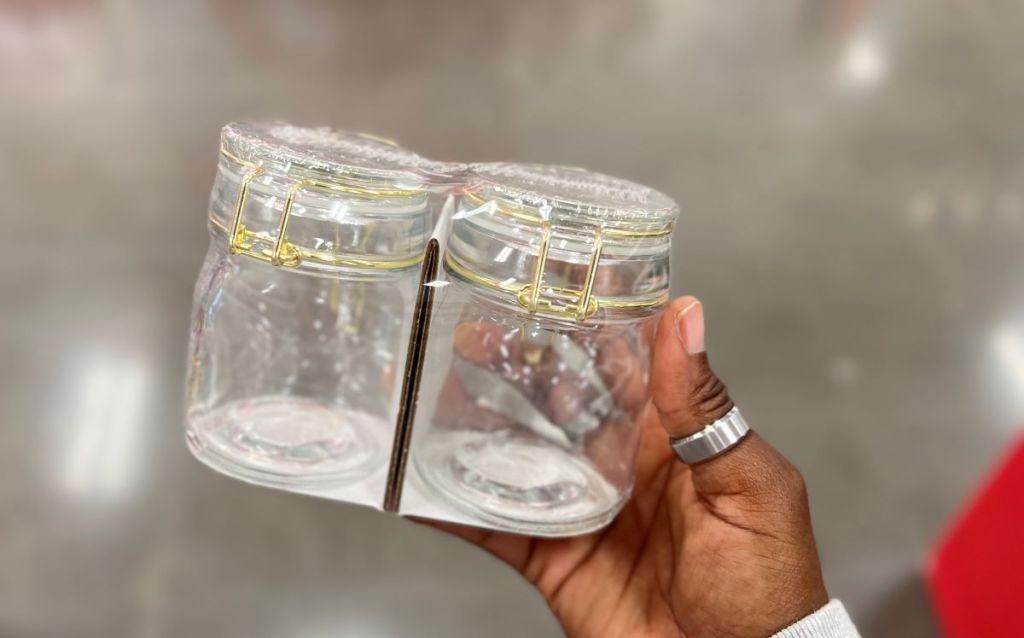 Hand holding a pack of two mini glass jars