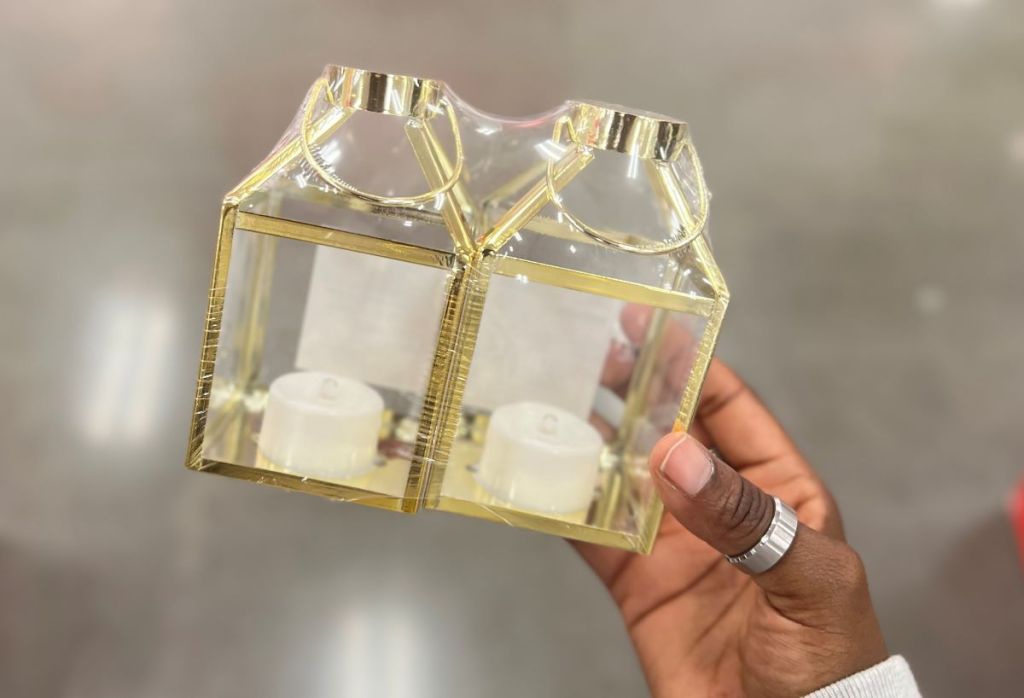 Hand holding a 2-pack of mini gold lanterns
