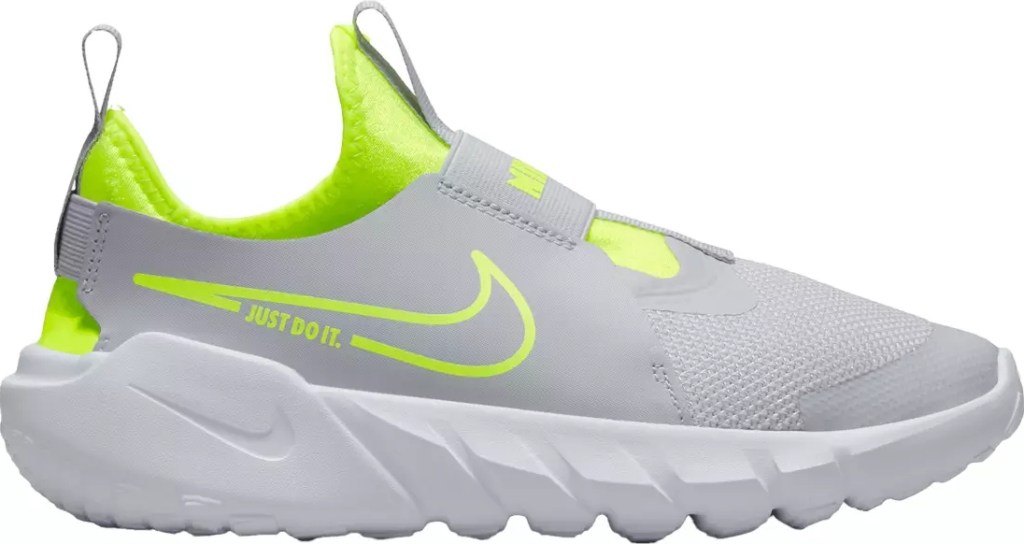 Grey, white, and lime green Nike kids shoe
