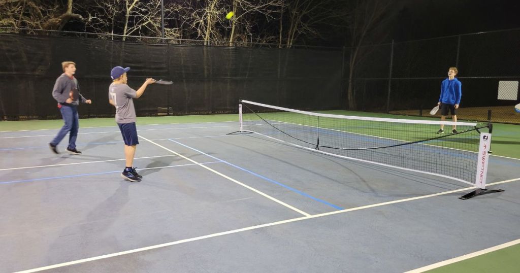 boys playing Pickleball on outdoor court