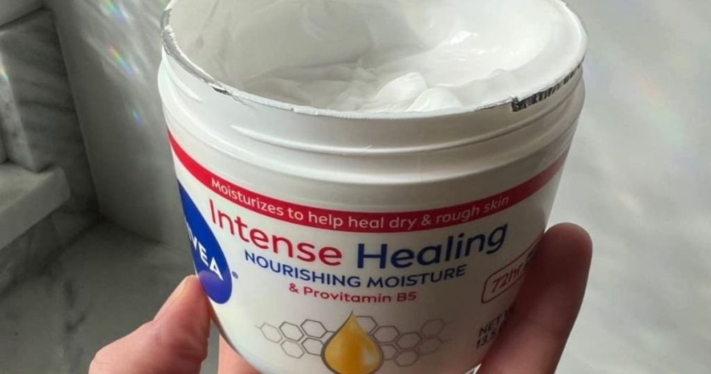 Opn Jar of Nivea Intense Healing Cream in hand