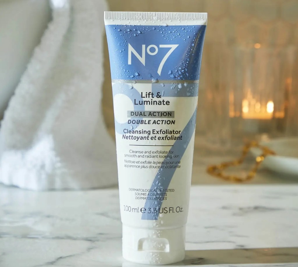 Bottle of No7 Lift & Luminate Dual Action Cleansing Exfoliator on a counter