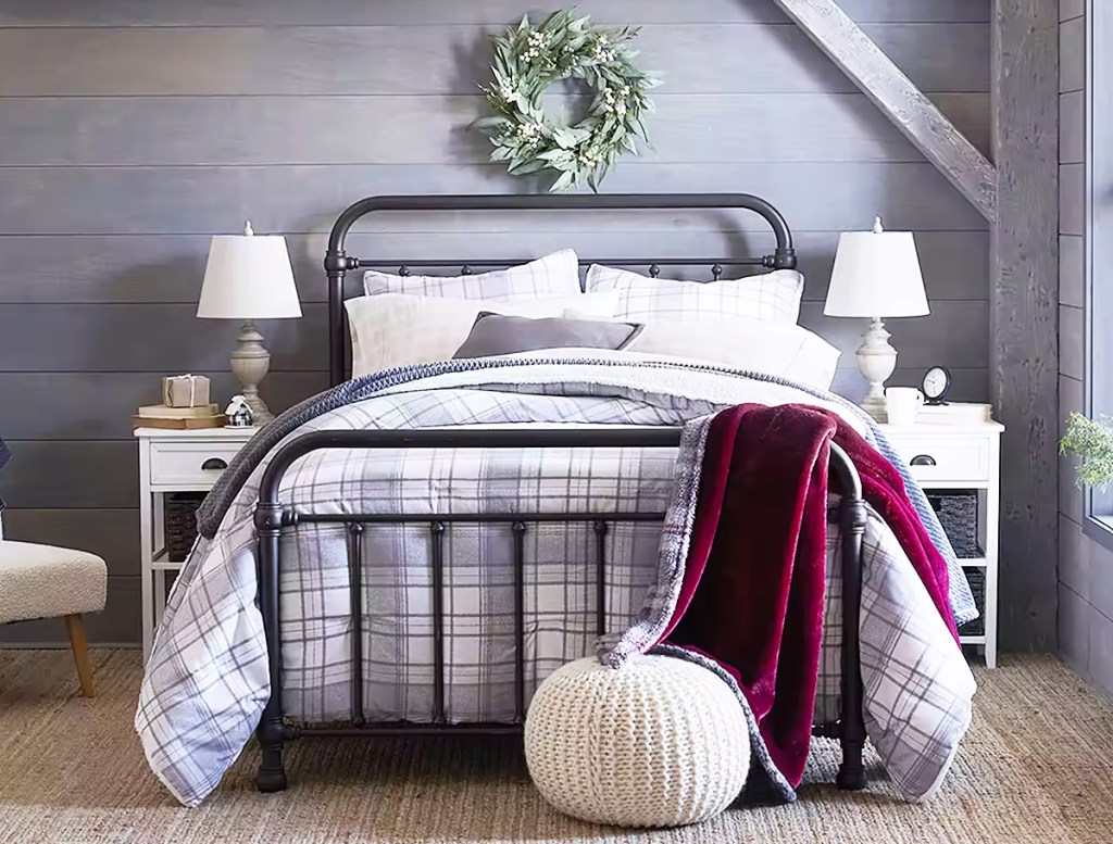 plaid comforter set on a bed with a red throw blanket