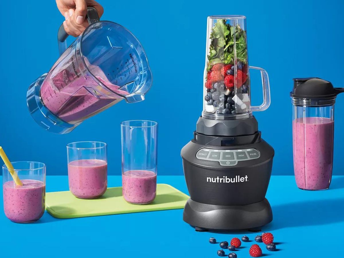 person pouring a smoothie from a ninja blender pitcher