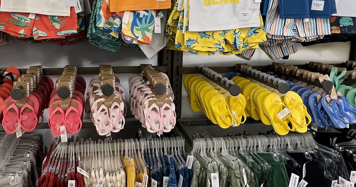 toddlers swimsuits and flip flops on display in store